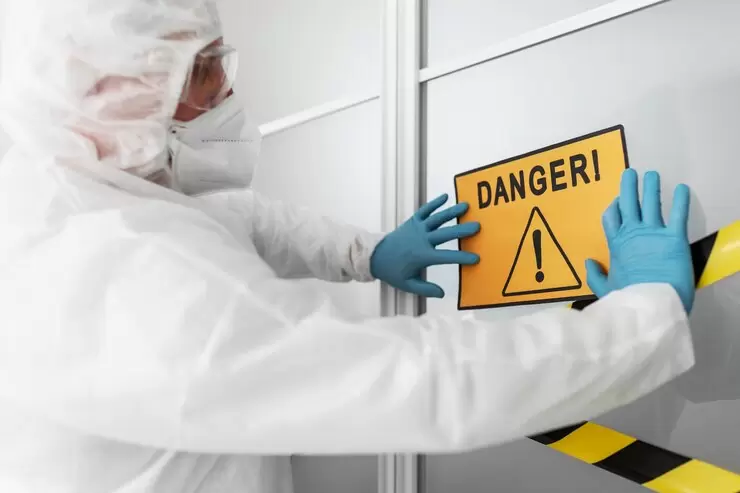 man-sticking-danger-sign-on-door